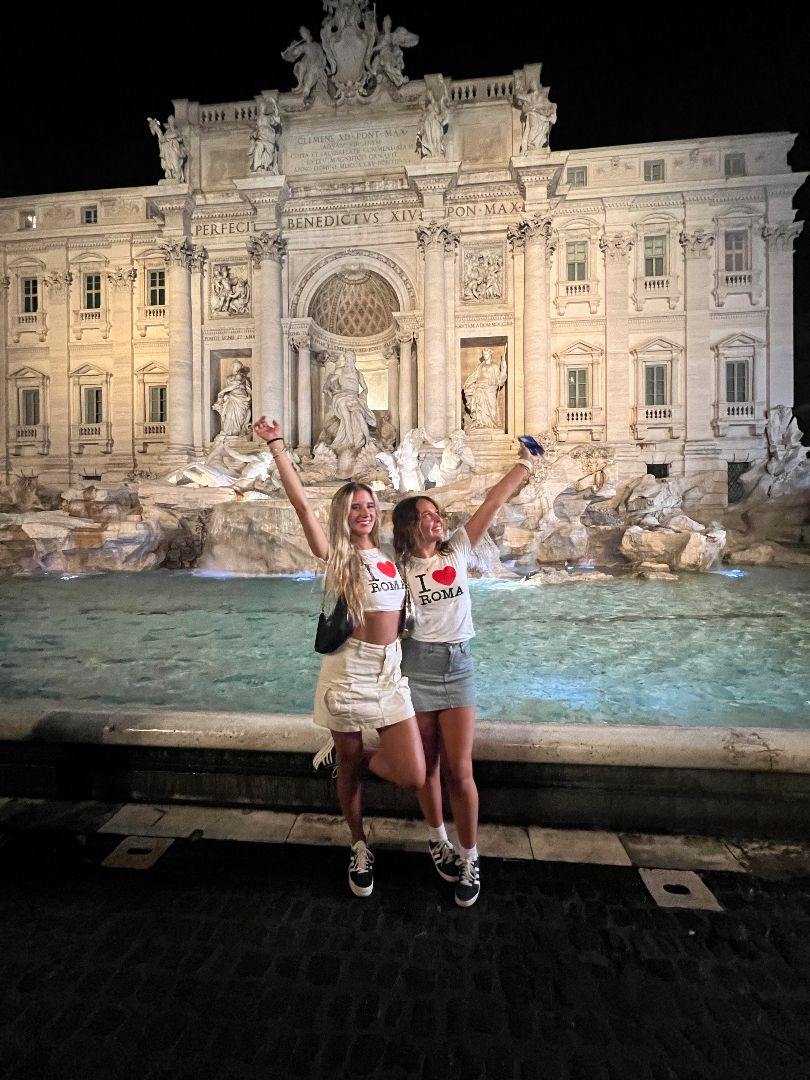 Giana and friend in front of the Trevi Fountain at night