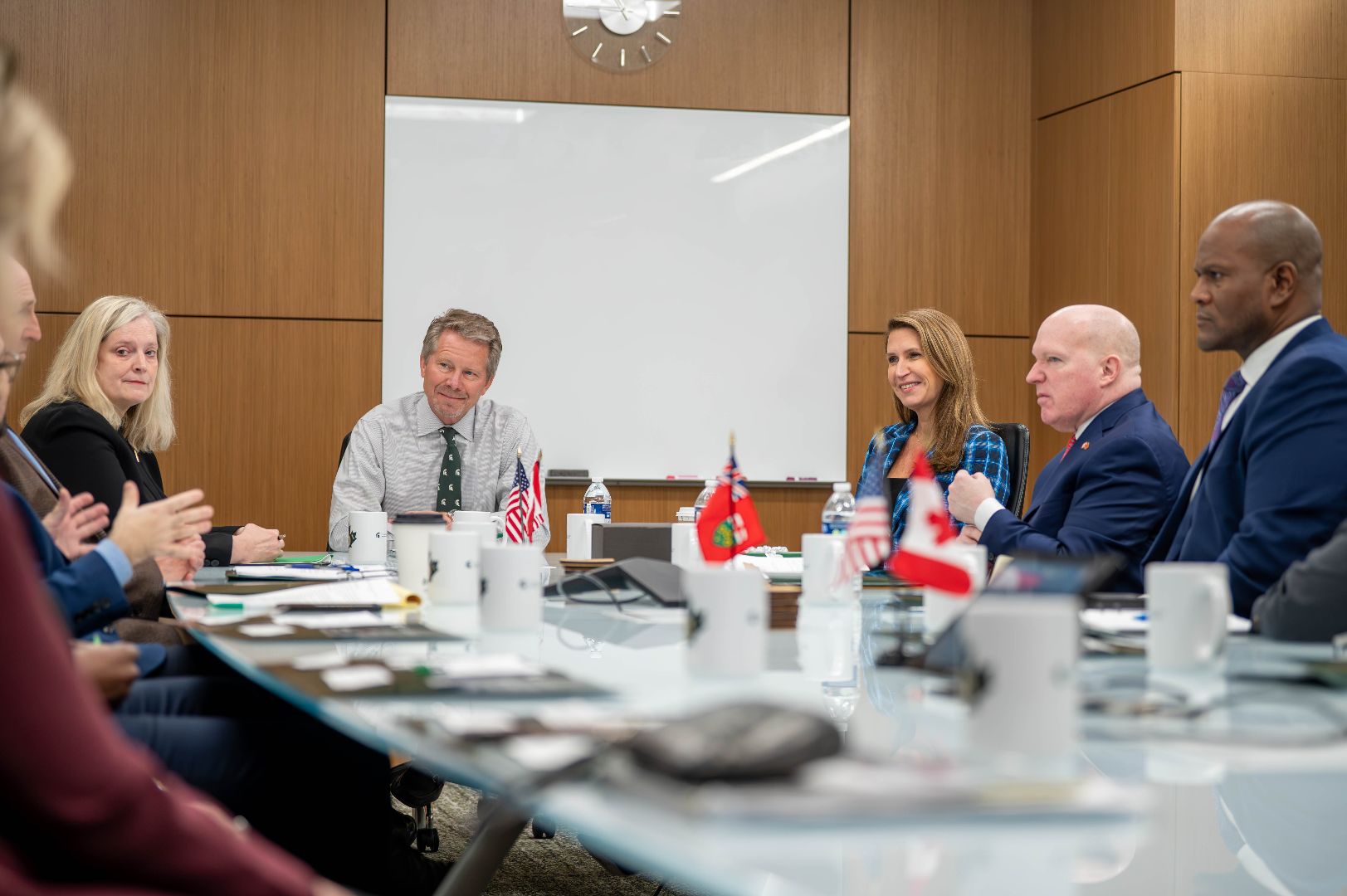 MSU, Michigan, and Ontario leaders around a conference table with President Guskiewicz.