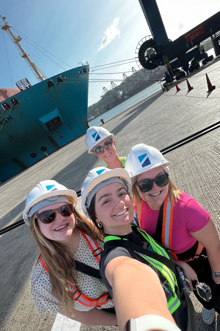 Monique and friends in front of a ship in the Panama Canal