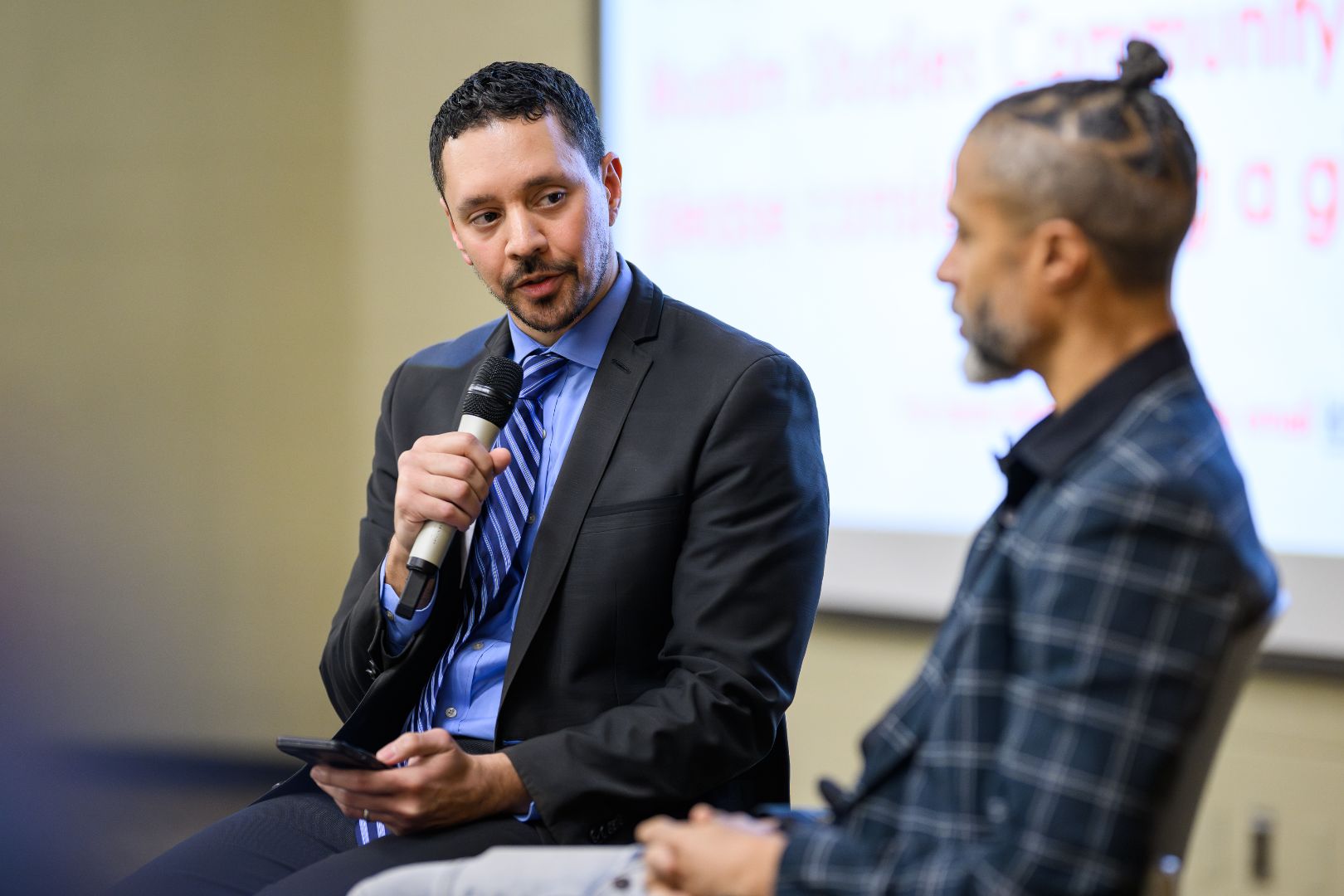 Mohammad Khalil and Abdul-Rauf answer questions on stage. 