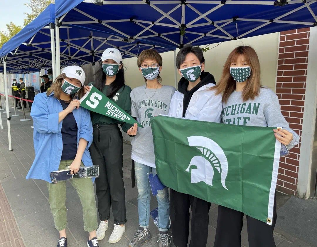 MSU alumni pose with Spartan flag in Shanghai
