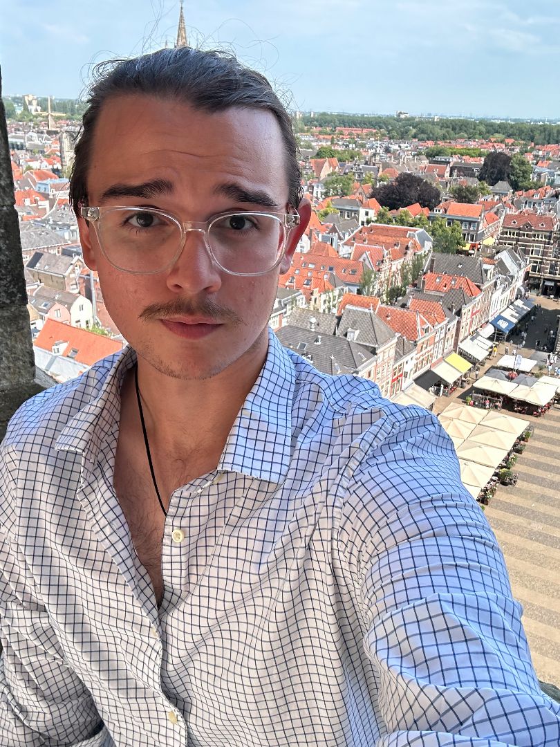 Vasily taking a selfie at the top of a building overlooking Amsterdam in the Netheralnds