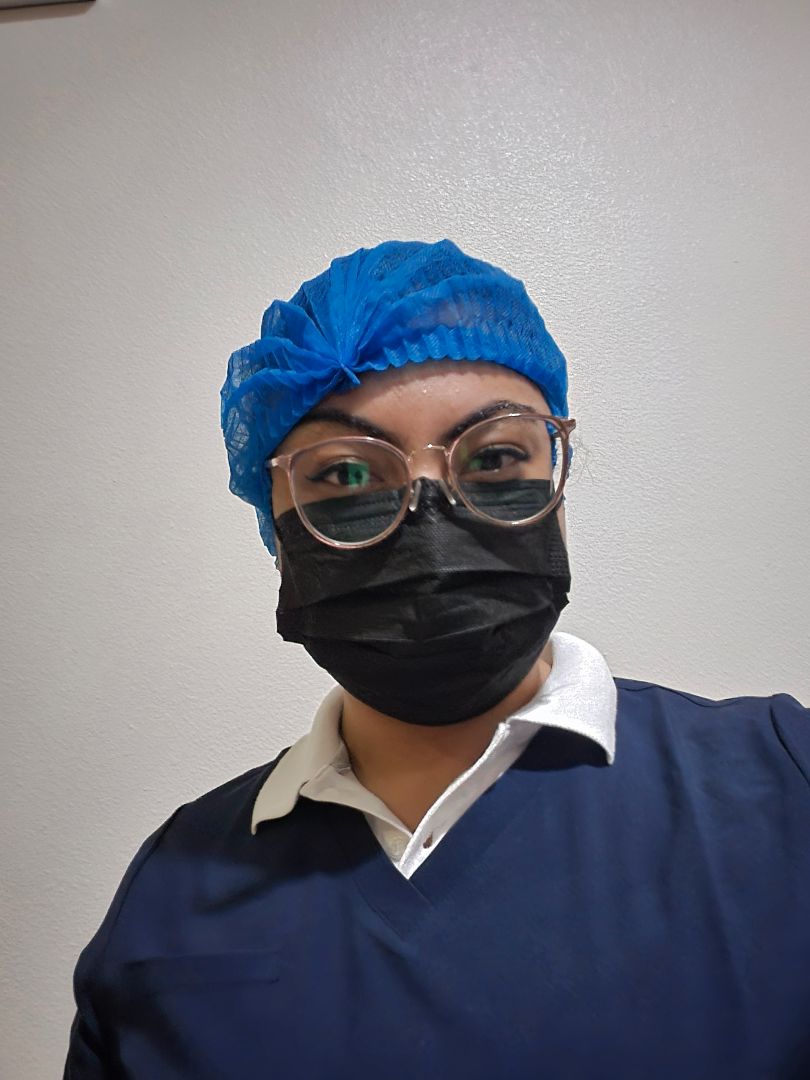 Amirah wearing blue scrubs in an operating room in Mexico