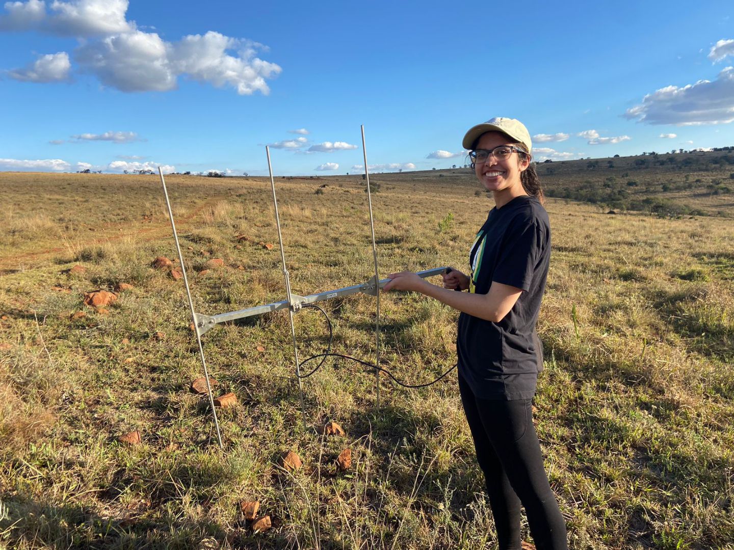 Elena in field with tracking antenna in South Africa