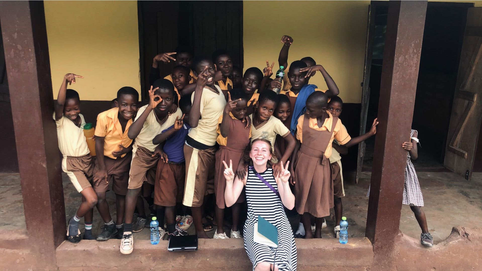 Jenna posing with local school children