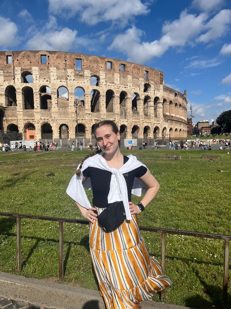 Olivia standing in front of the colesium in Rome