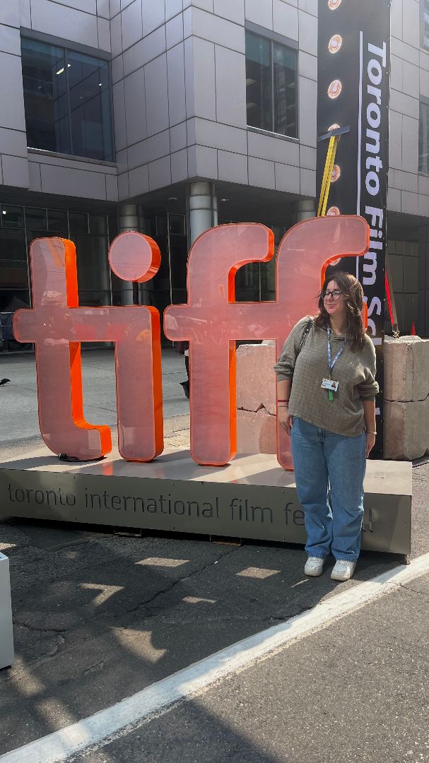 Caitlyn standing in front of the large outdoor TIFF sculpture