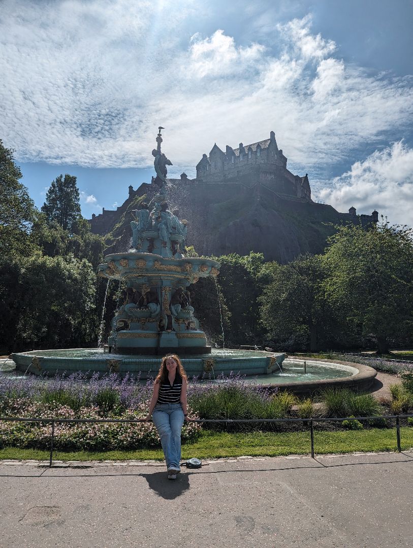 Sophie sitting near a fountain in Ireland