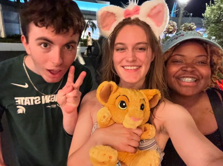 A’Lvinia with two friends - one holding a stuffed Lion King character