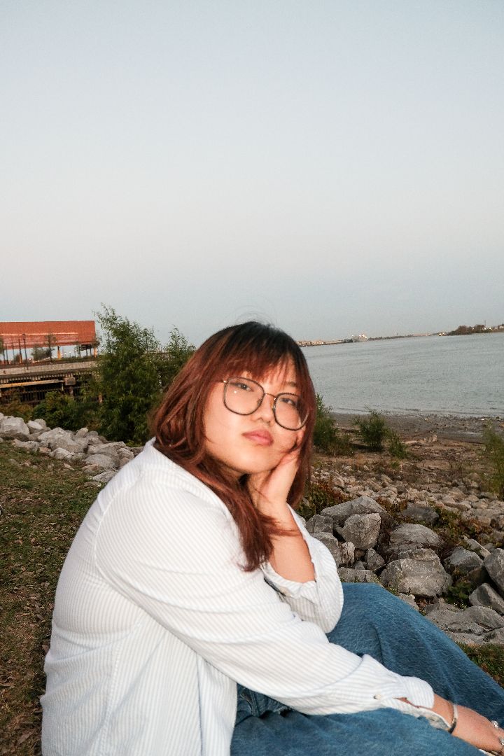Addie in front of a body of water