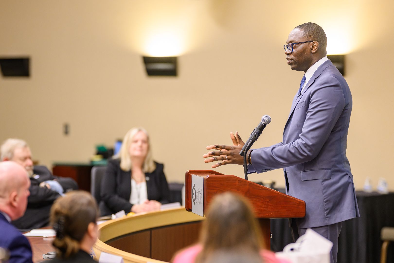 Lt. Governor Gilchrist speaking at a podium before an audience