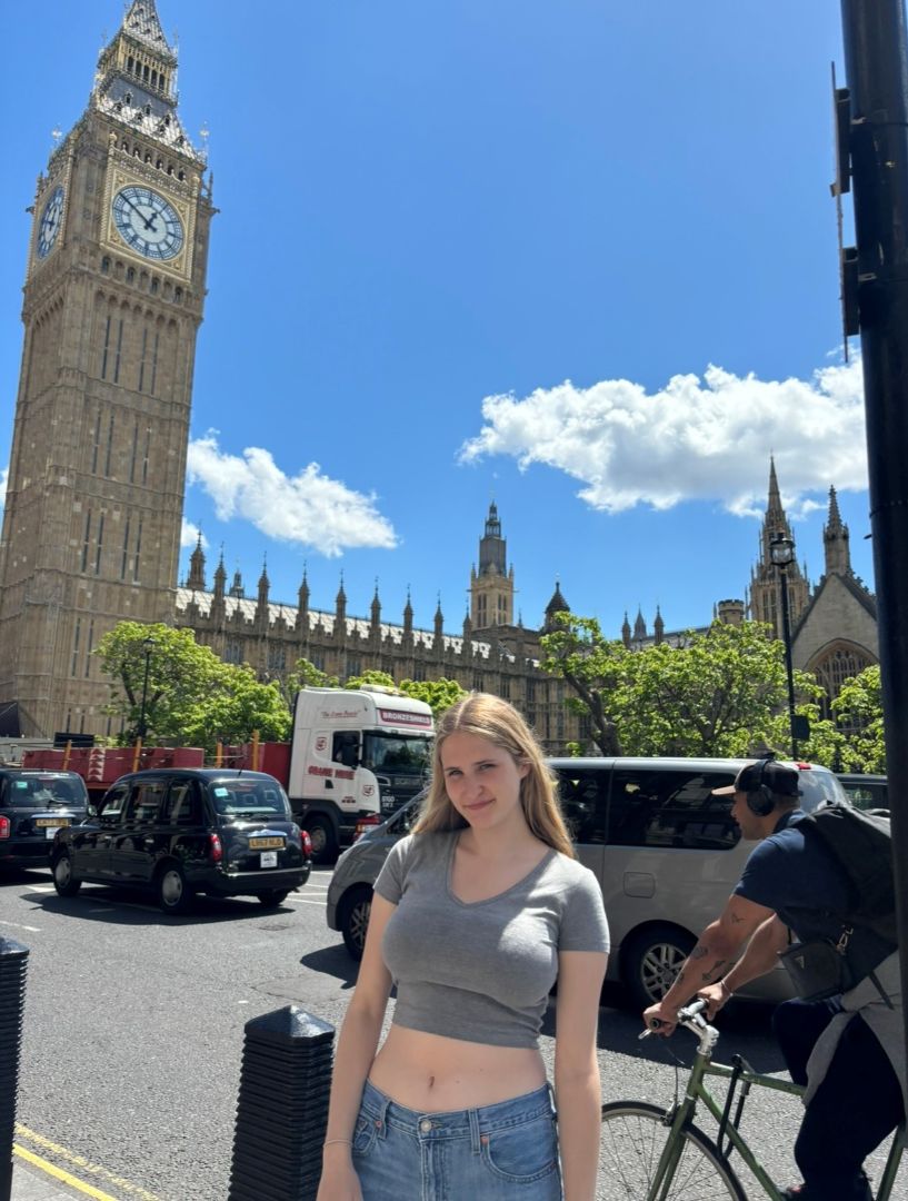 Esther standing on the street in front of Big Ben in London