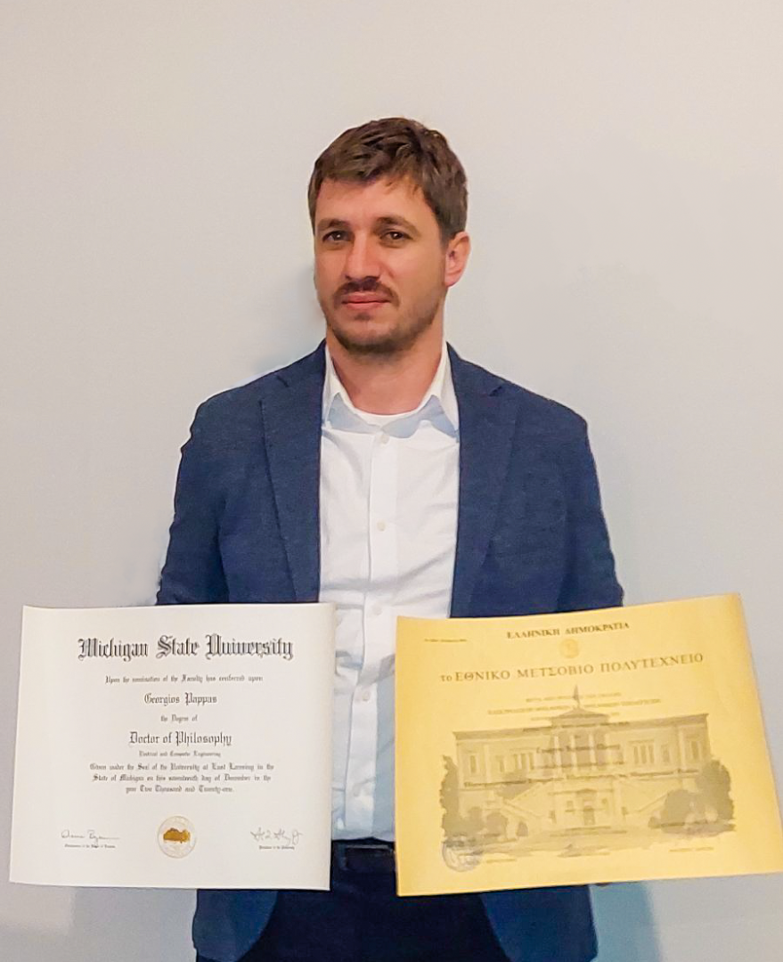 Georgios Pappas holding his two degrees