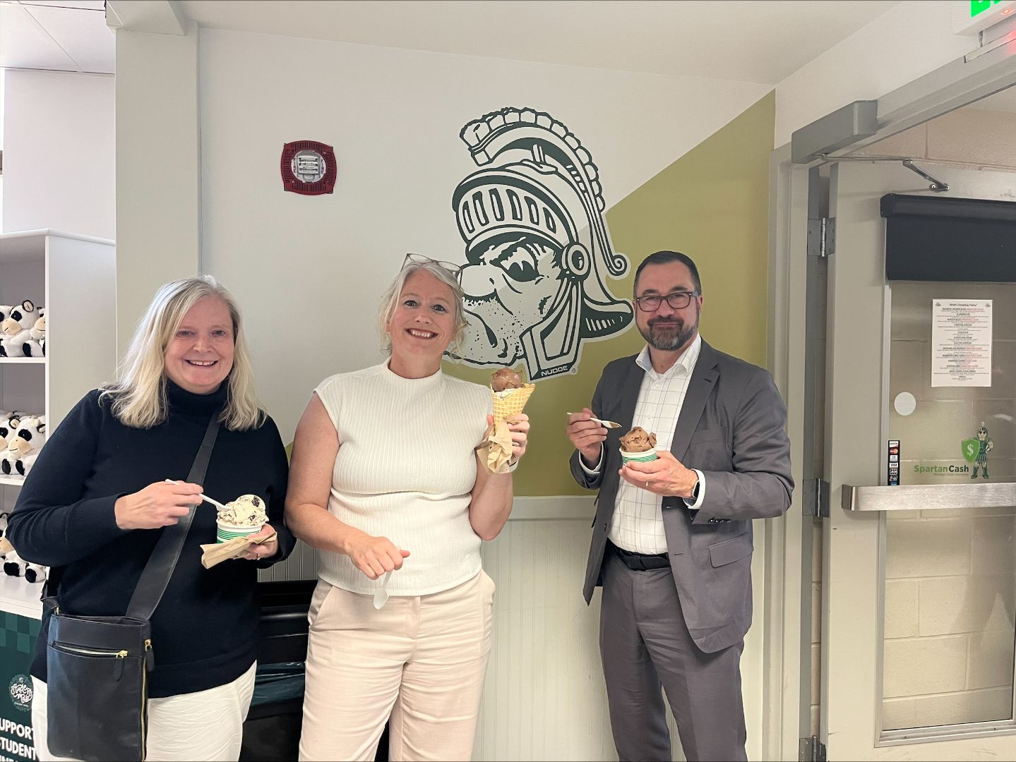Director Malouin, Vice Rector Gélineau, and Ms. Dionne at the MSU Dairy Store posing with ice cream.