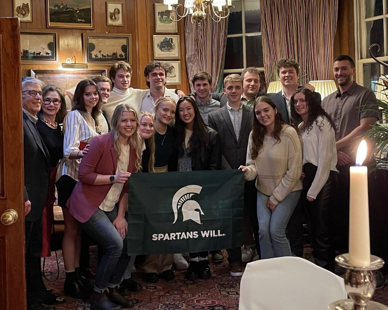 Group of MSU students holding Spartan flag in London