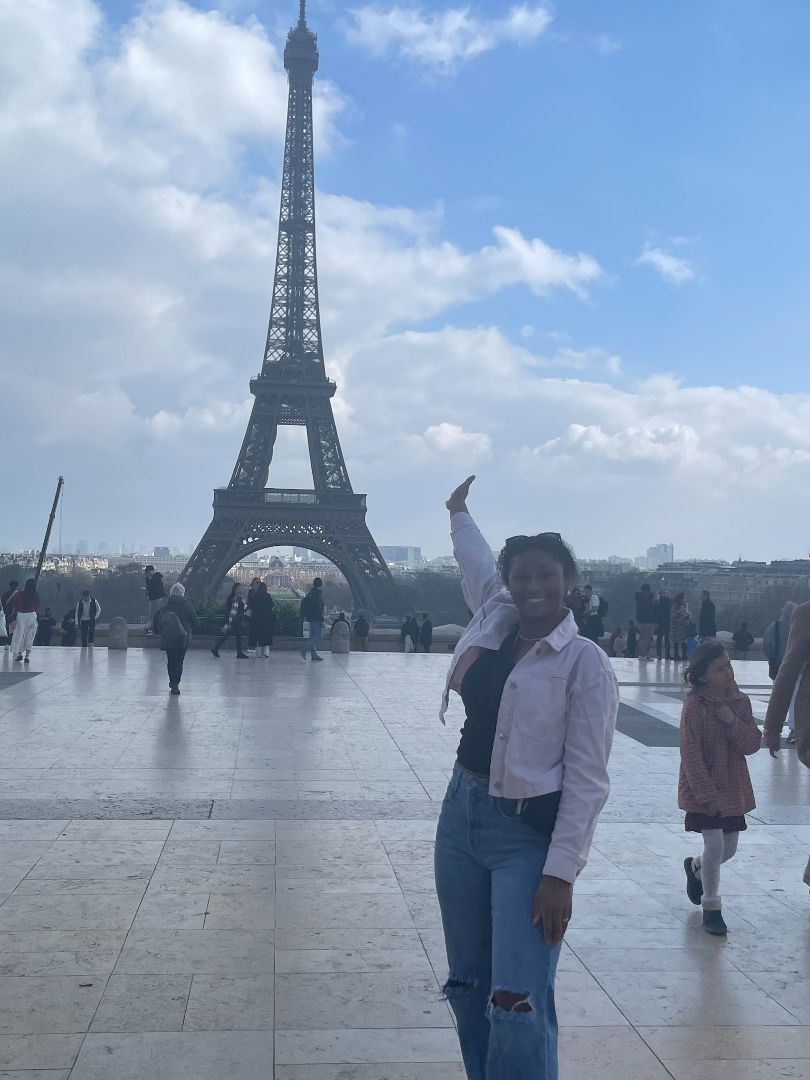 Paris France posing in front of the Eiffel Tower.
