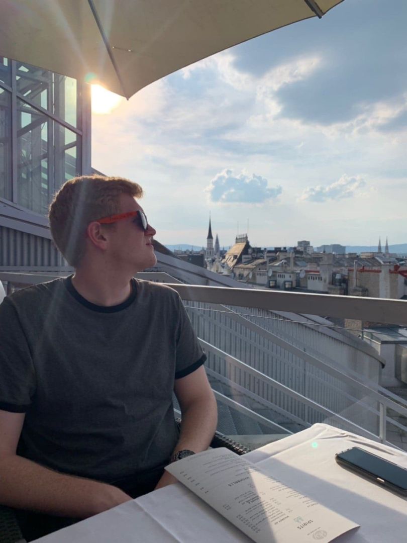 Jared looking over German cityscape from high rise restaraunt