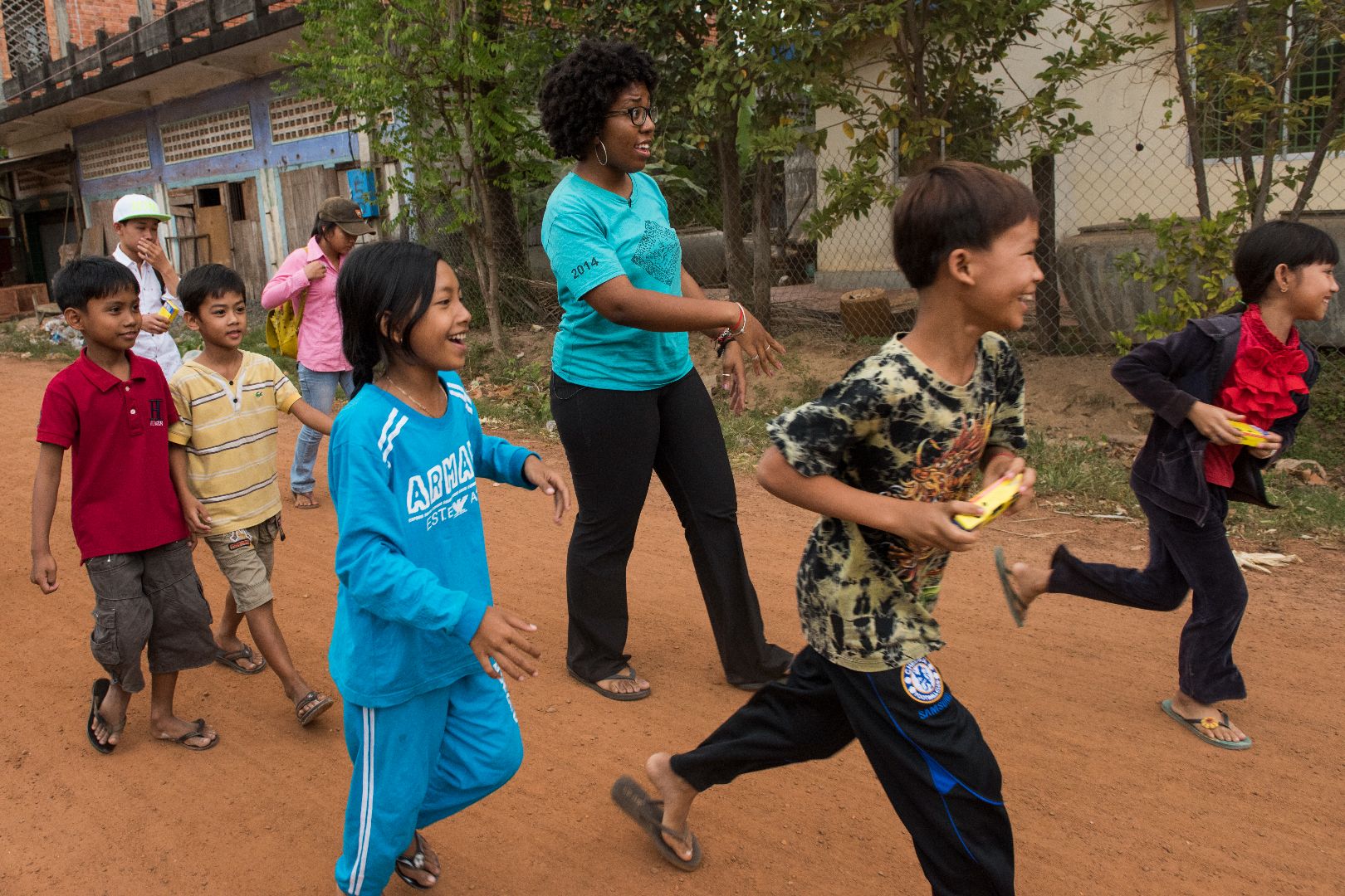 A Peace Corps volunteer walks with a group of Cambodian students