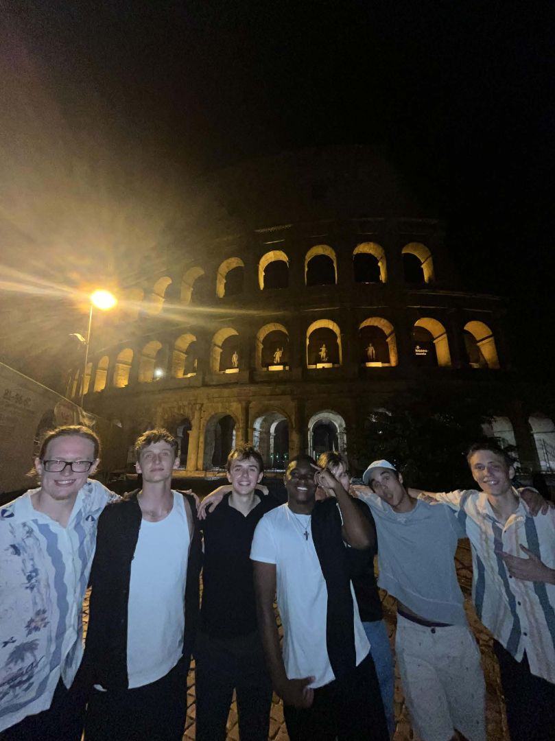 Charles and friends standing in front of the Roman Colesium at night