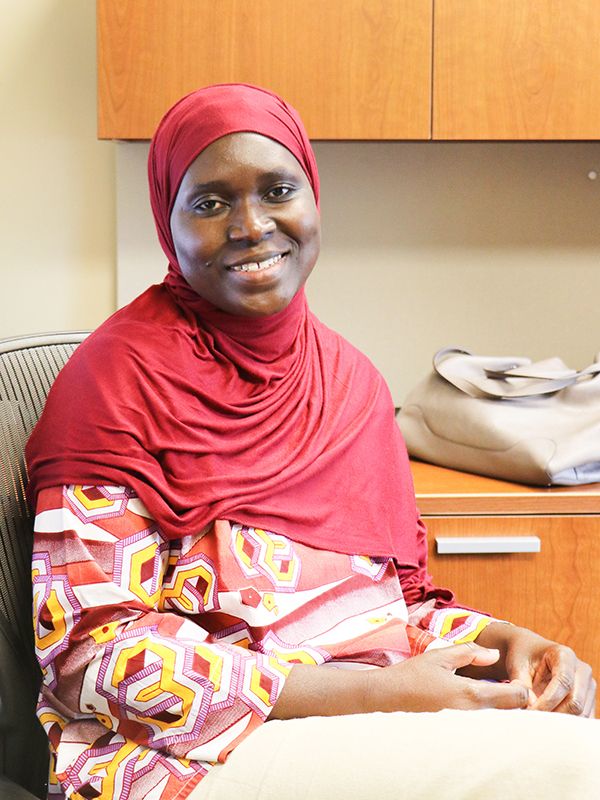 Female [Awa Sarr] seated in her office