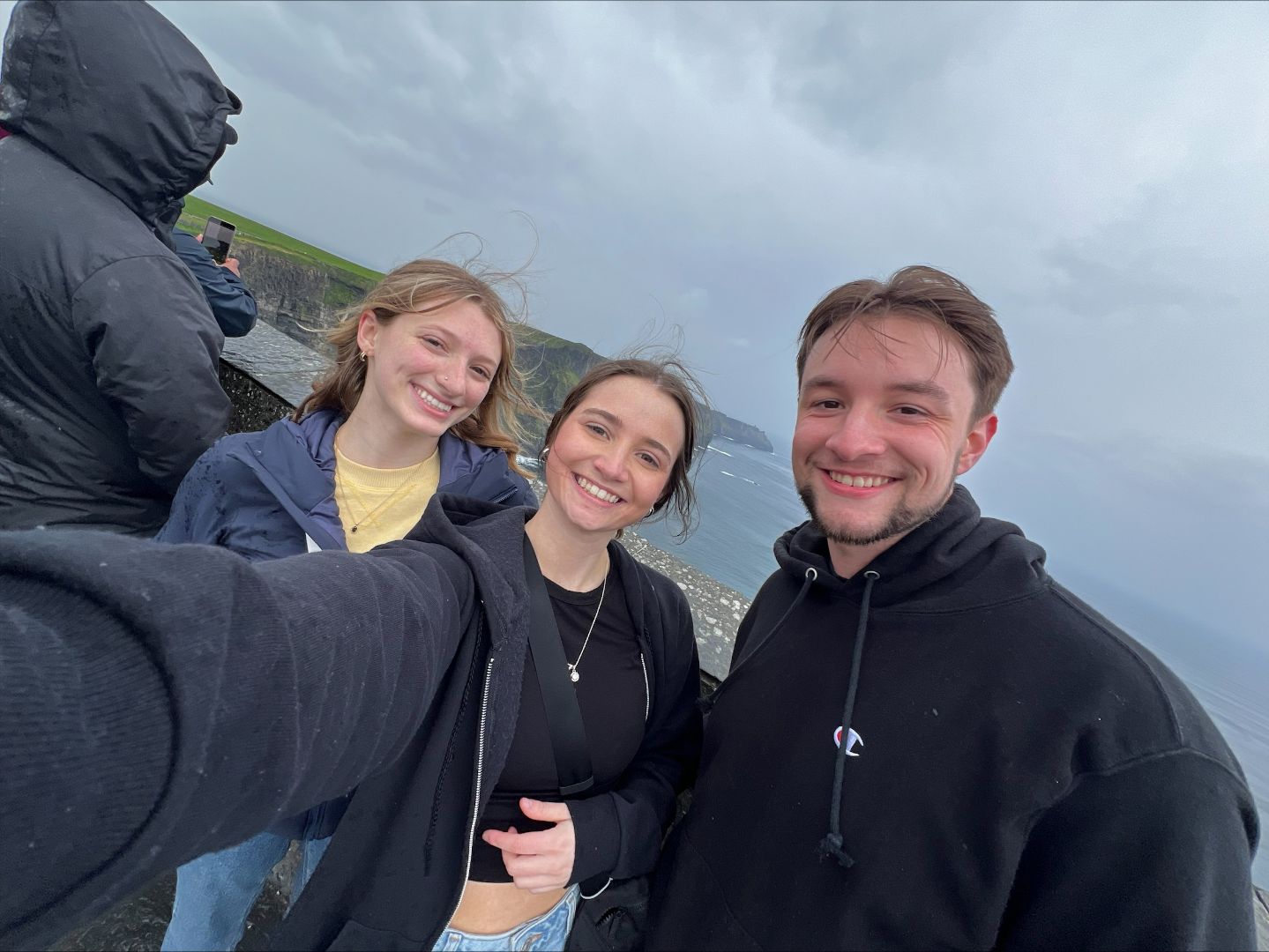 Jordan and friends taking a selfie at the Cliffs of Moher in Ireland