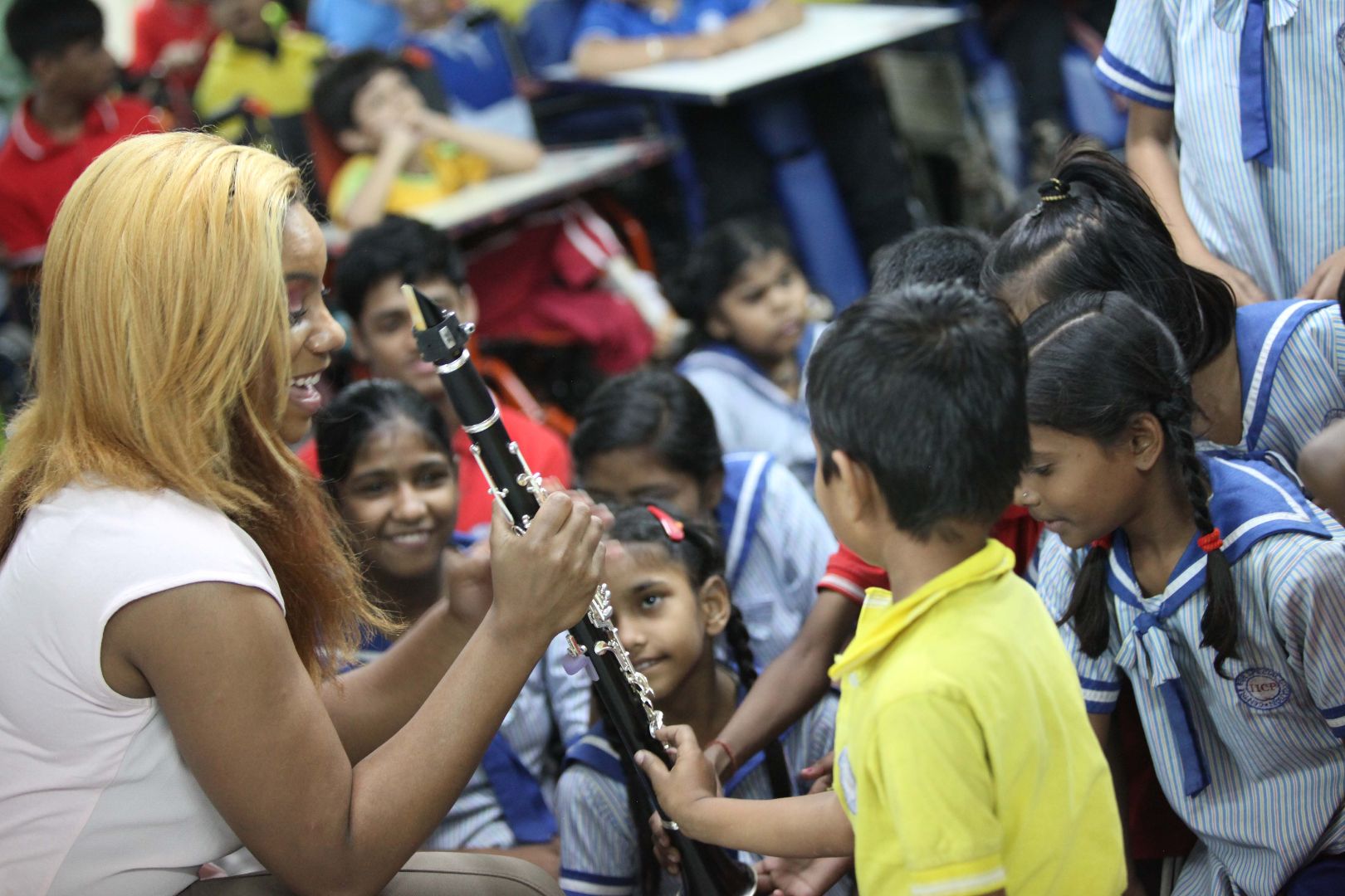 Marissa showing clarinet to local Indian children