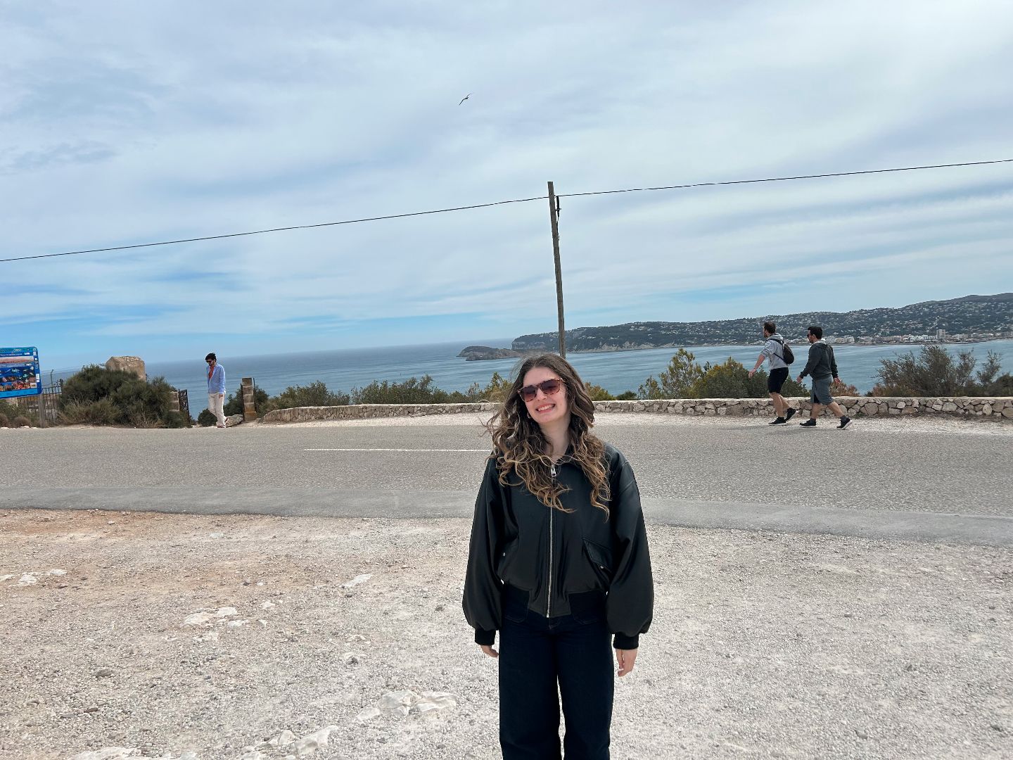 Caitlin standing by the sea in Spain