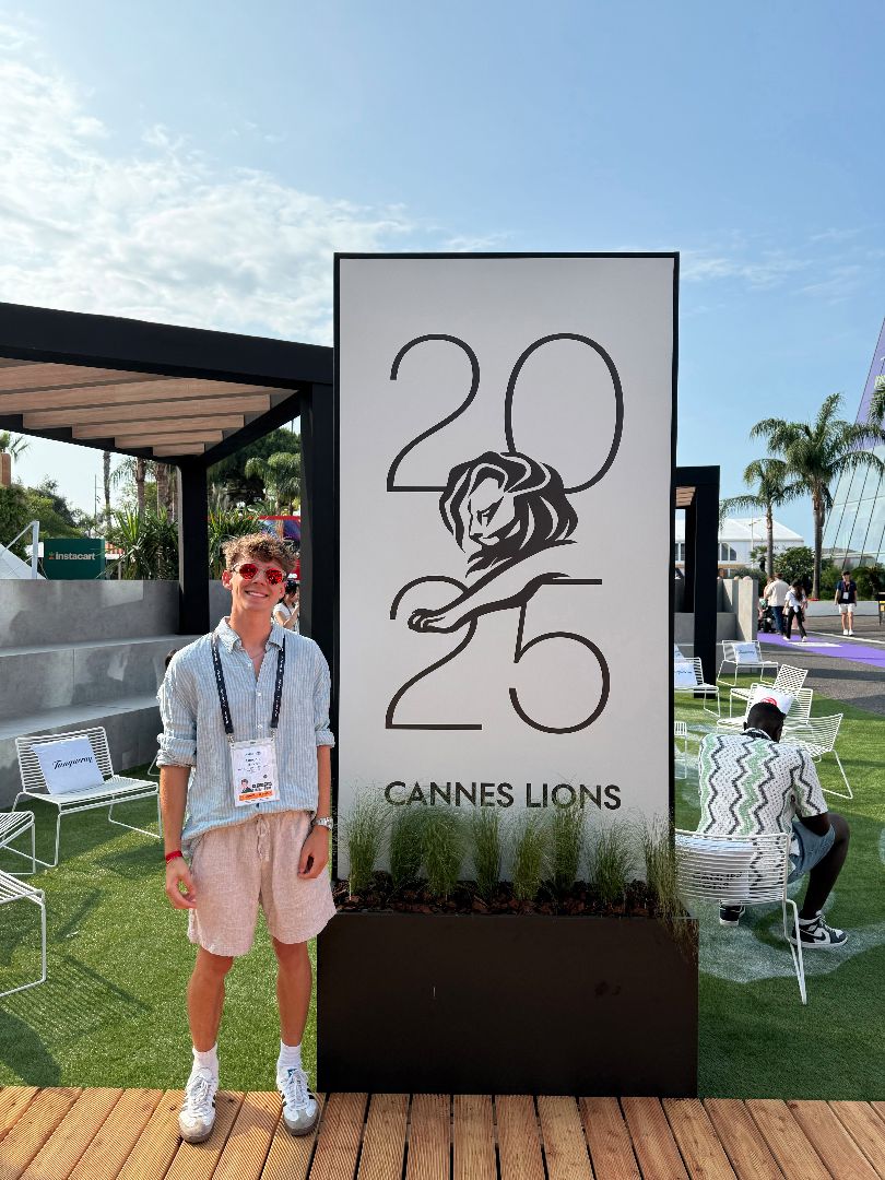 Landon standing next to a sign for the 2025 Cannes Lions festival