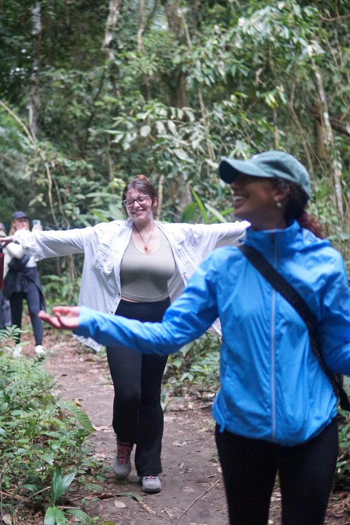 Shealyn with her arms spead open in the rainforest of Peru