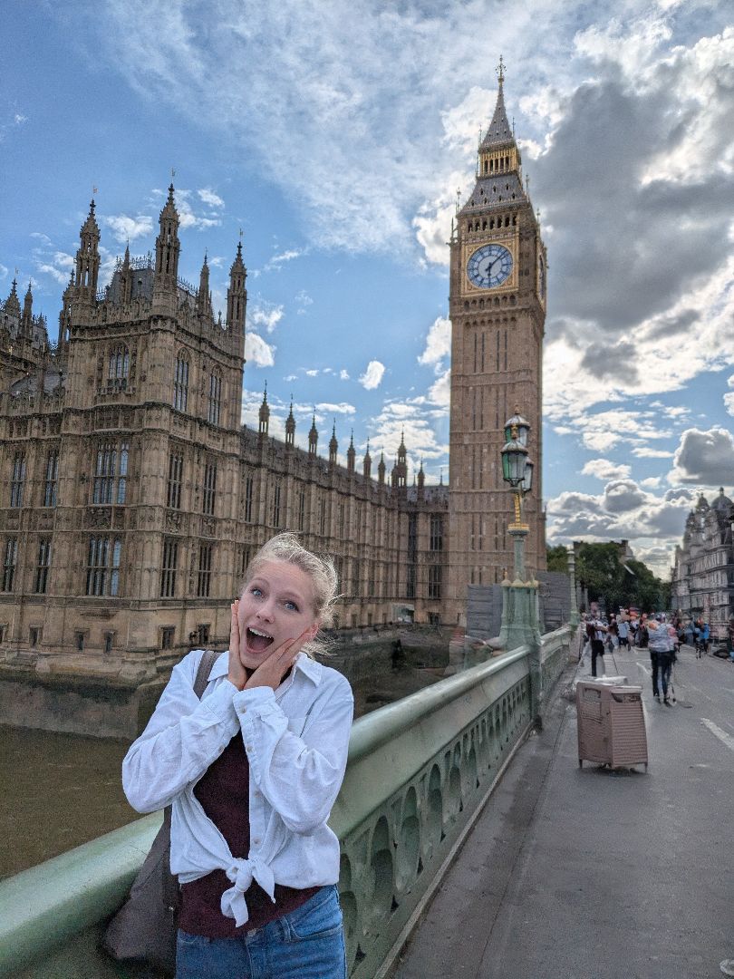 Megan acting surprised as she poses in front of Big Ben in London