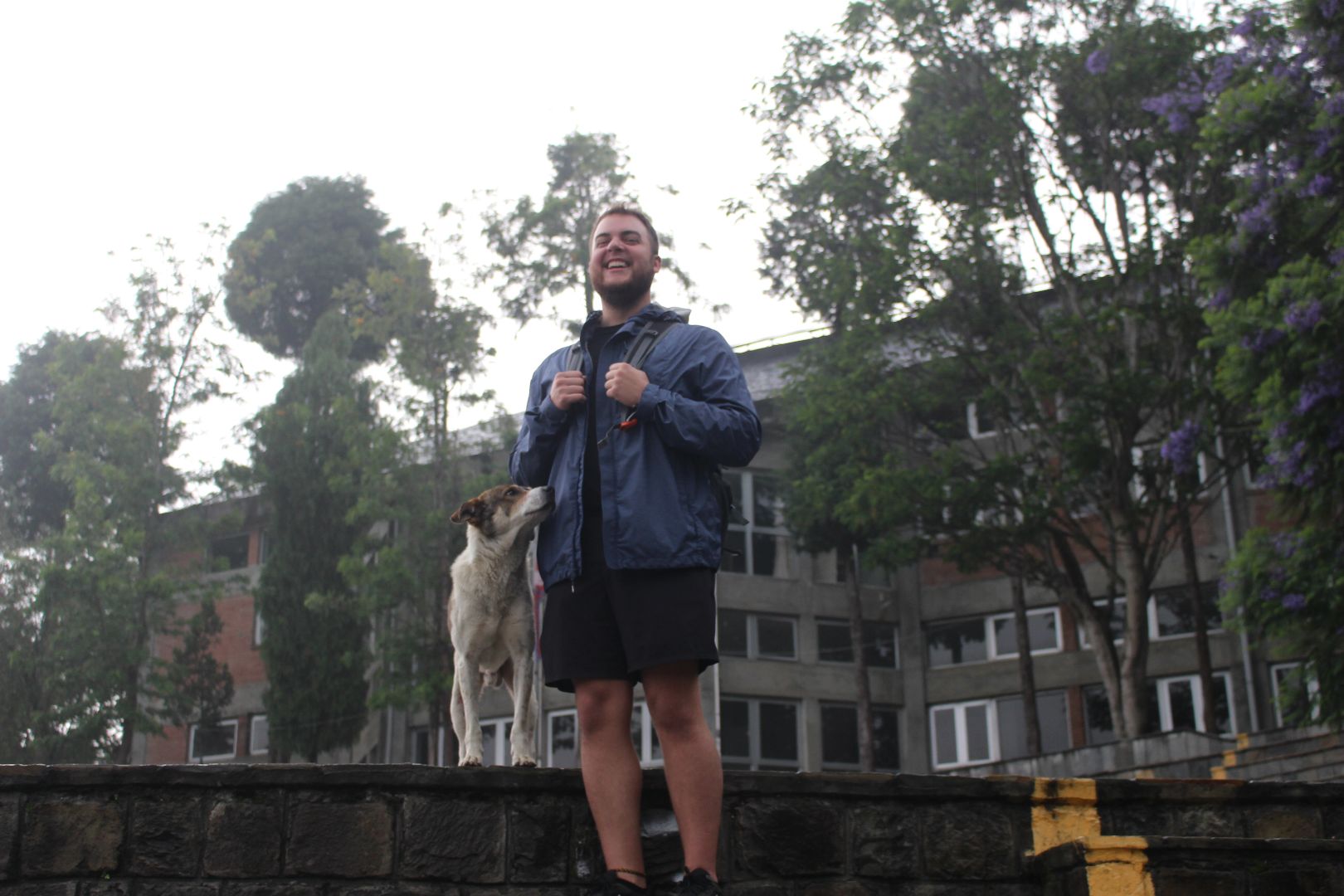 Zachary standing with dog in Nepal