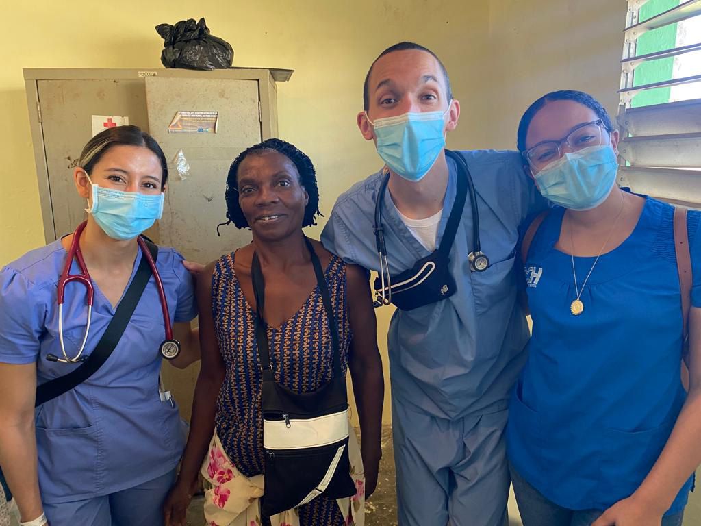 Group shot of 3 MSU med students in a clinic in the Domincan Republic