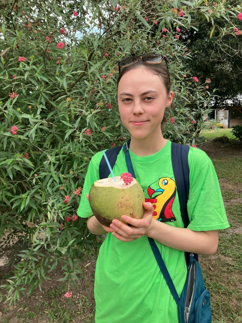 Carol holding a cococut drink in Belize