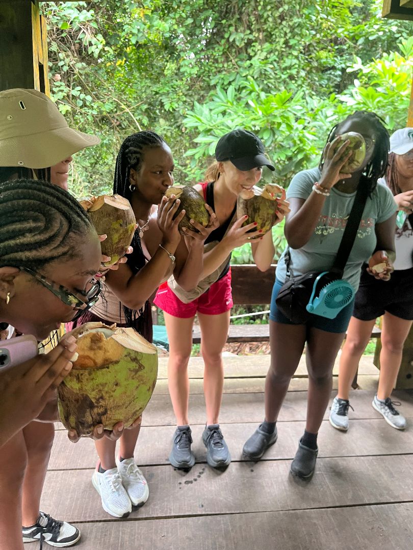 Anabeth and friends drinking out of coconuts in Ghana