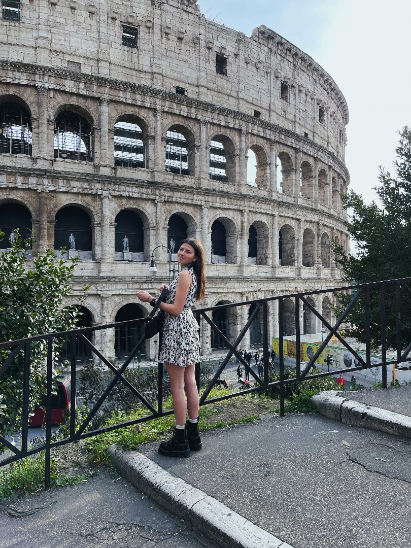 Riley standing in front of Colesium in Rome.