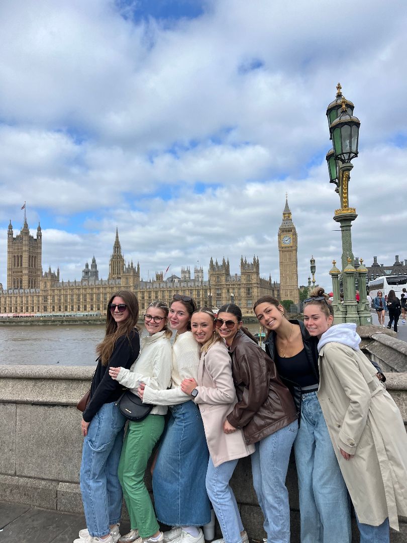 Hailey and friends pose the River Thames with parliament in the background