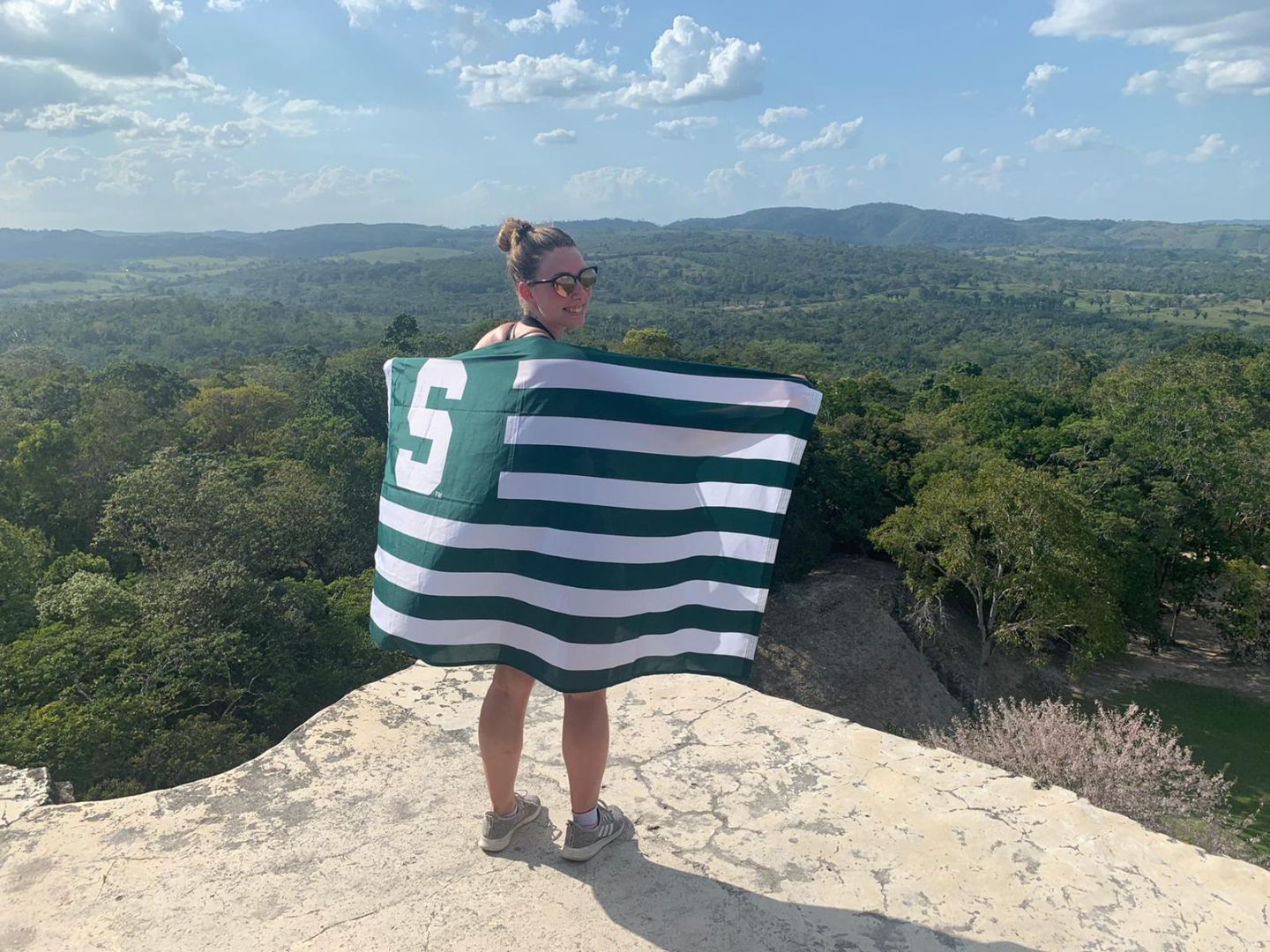 Stephanie Wheeler with Spartan flag in Belize