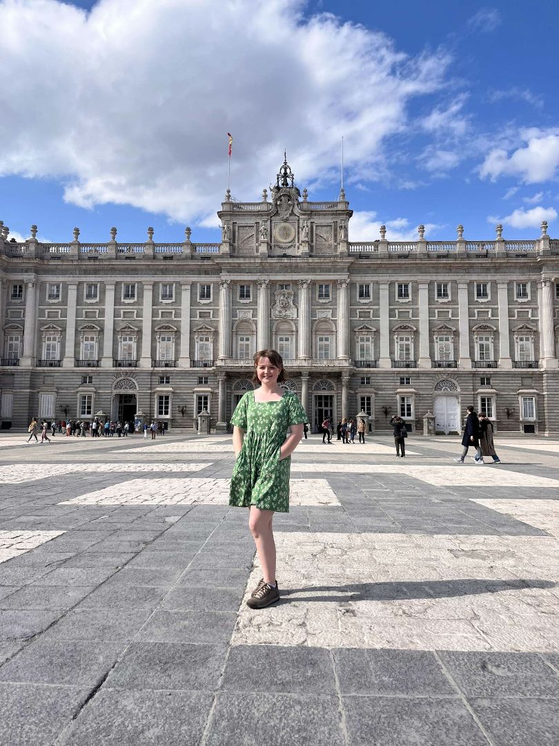 Allison standing in front of the Royal Palace of Madrid in Spain