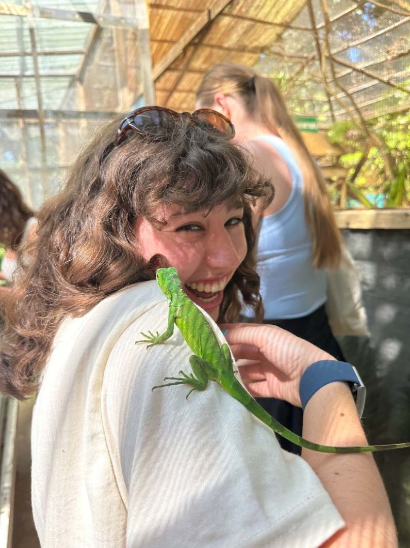 Delaney with a green lizard on her shoulder