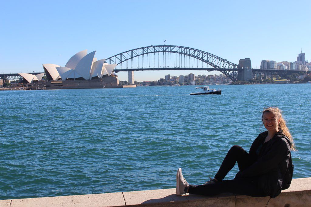 Courtney in Australia sitting with Sydney Opera House in background