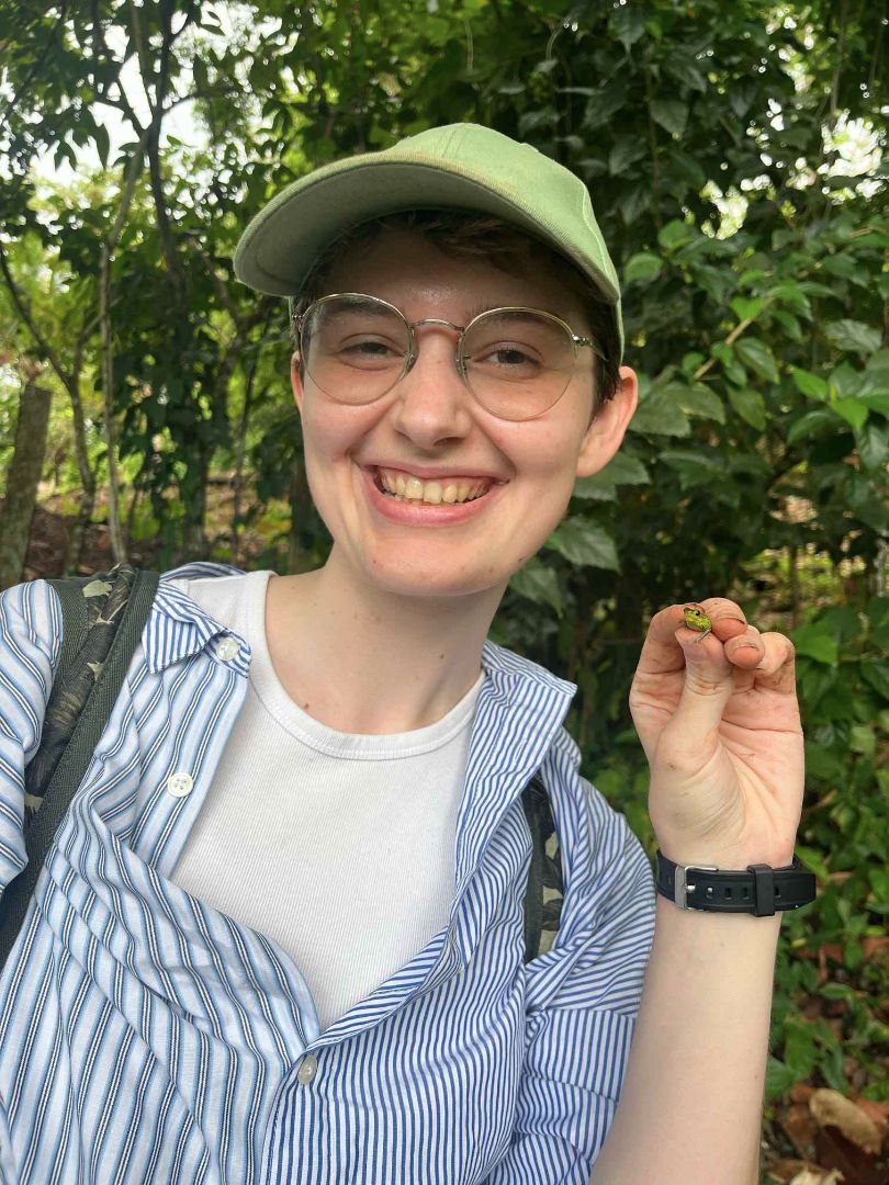 A. Proudfoot with a poison frog in Panama