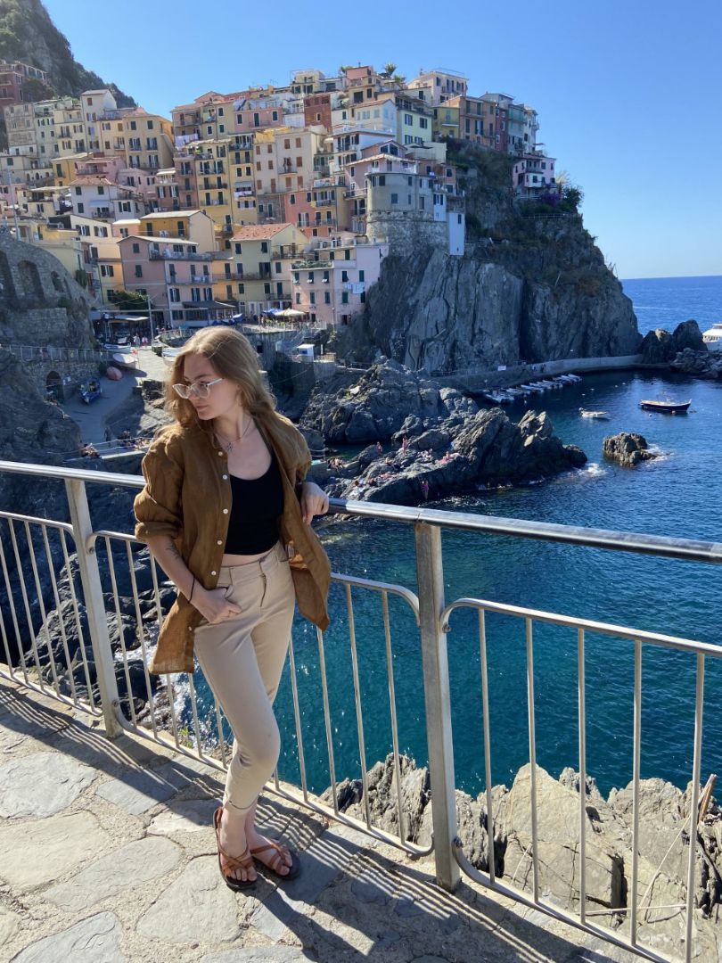 Ren standing near railing in front of the sea in Cinque Terre