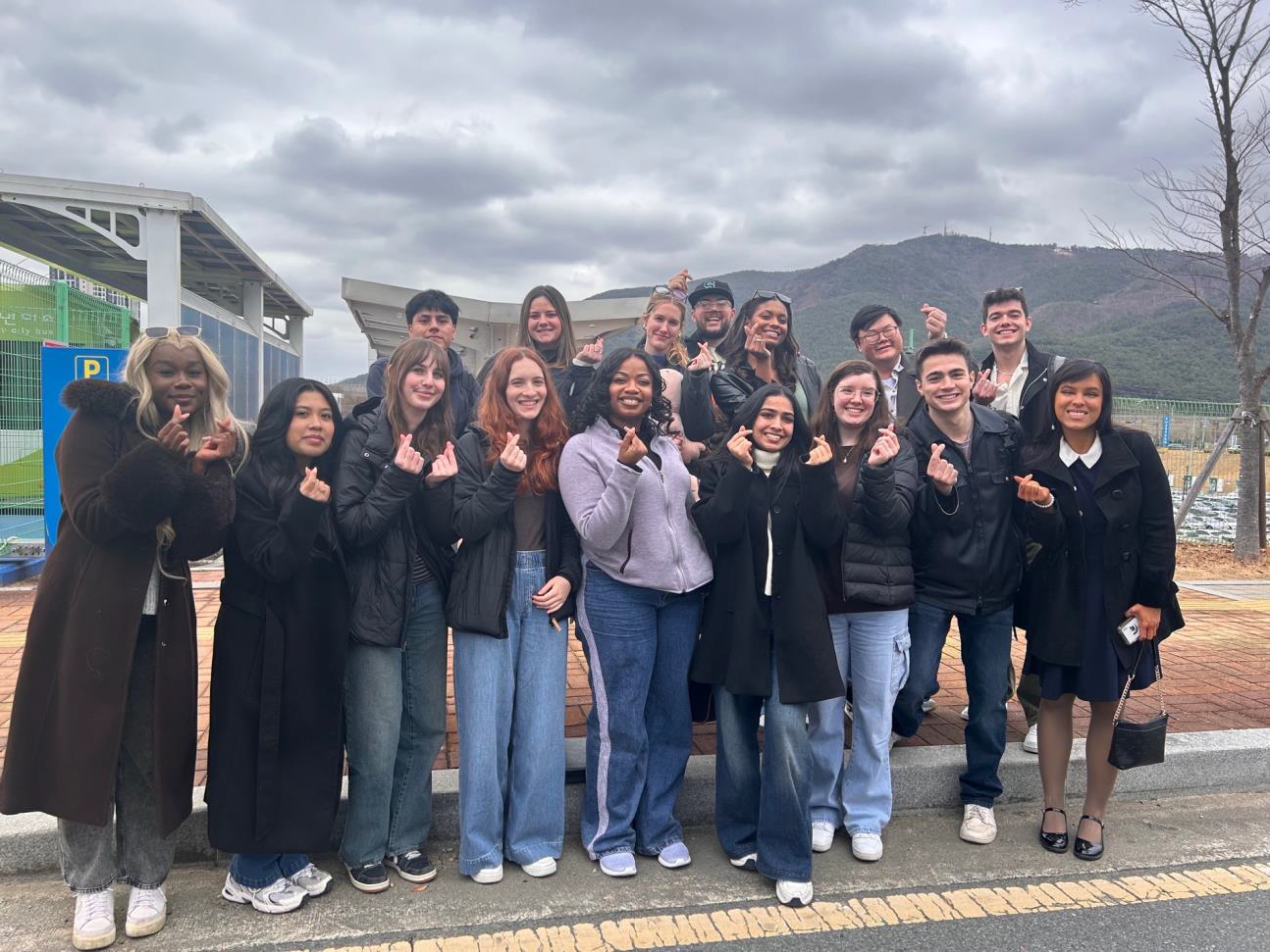 Group of MSU students posing for a photo in South Korea while snapping their fingers