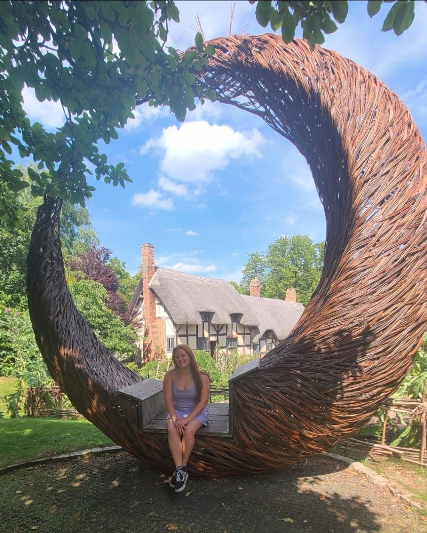 Shelby sitting in iconic willow sculpture in Stratford