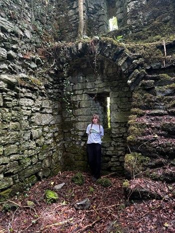 Lilith standing inside ancient ruins off the Cong Forest Nature Trail
