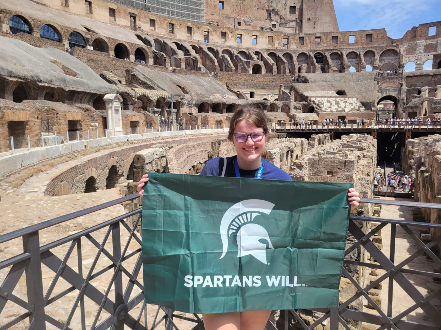 Hannah holding Spartan flag inside Colesium in Rome, Italy