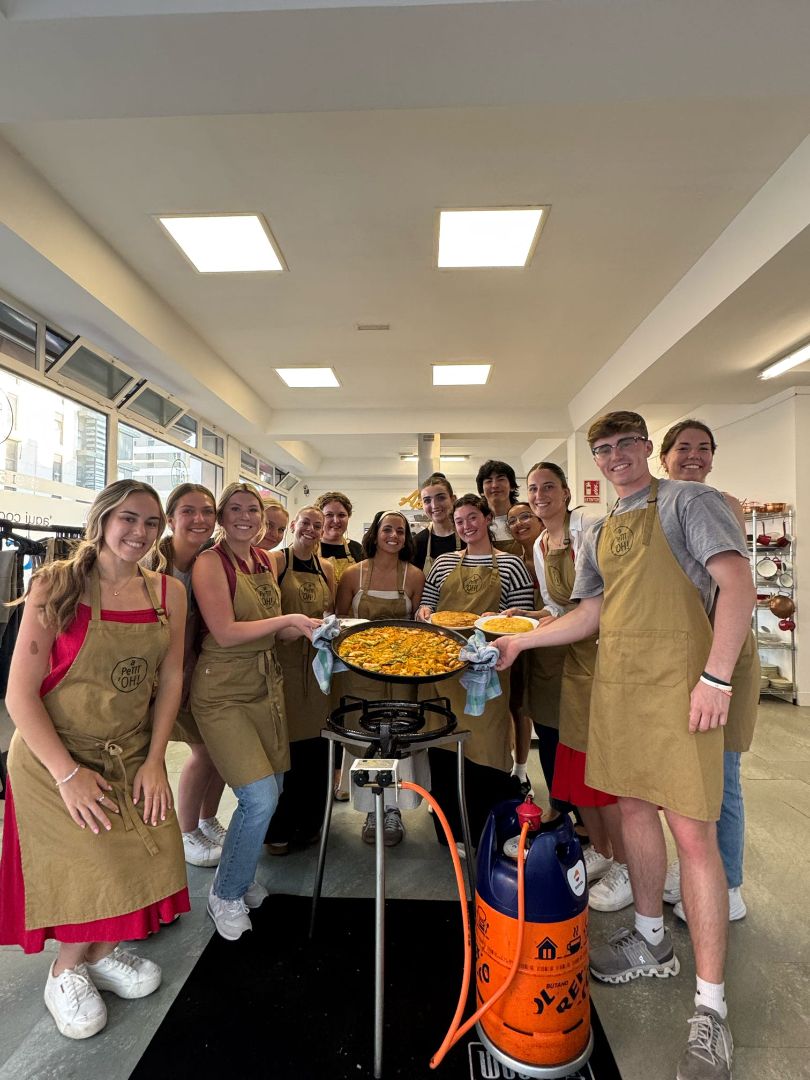 Group of students cooking paella in Spain