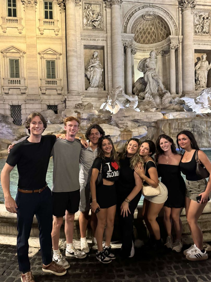 Group of students posing in front of the Trevi Fountain in Rome