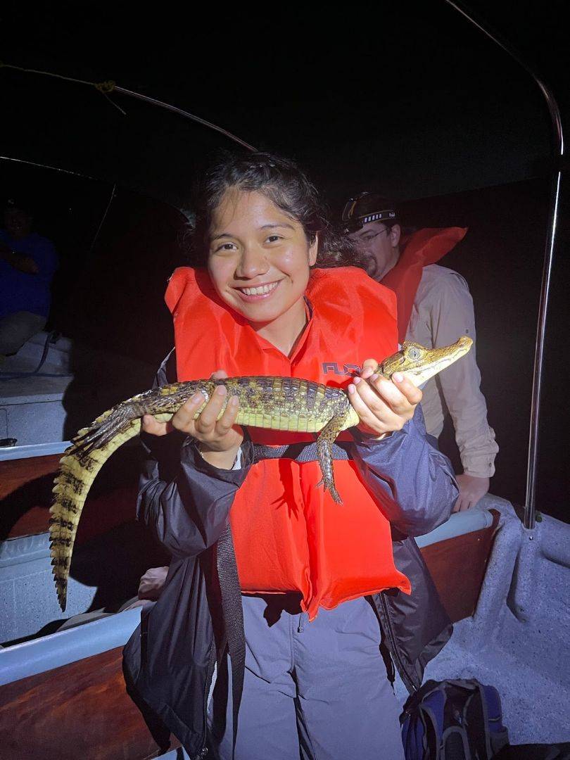 Michelle holding a baby caimen during a night excursion in Panama