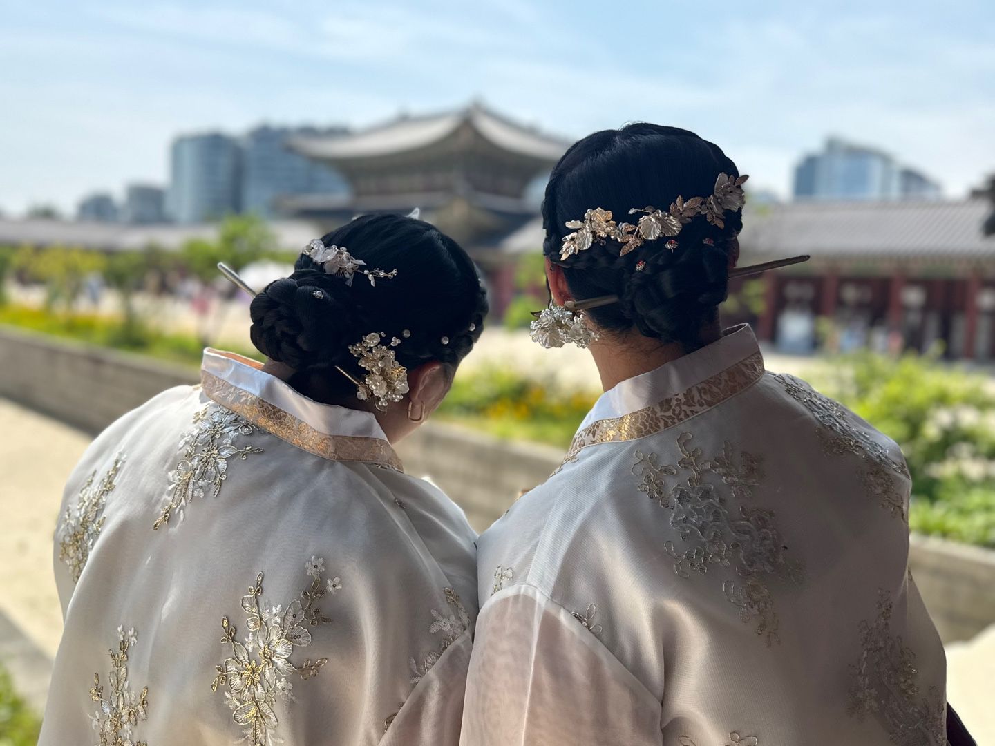 Hanaa and freind with beautiful flowers in their hair overlooking Seoul